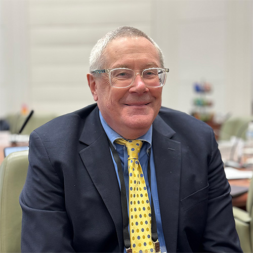Scott Schoedler smiling in a navy suit